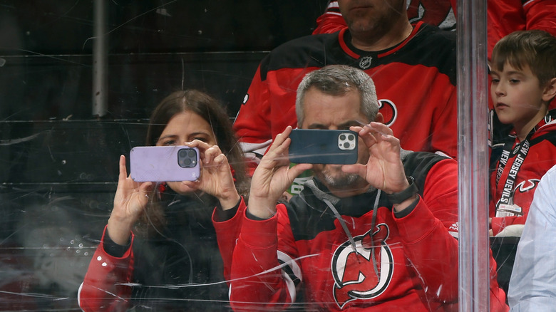 Fans take photos with iPhones