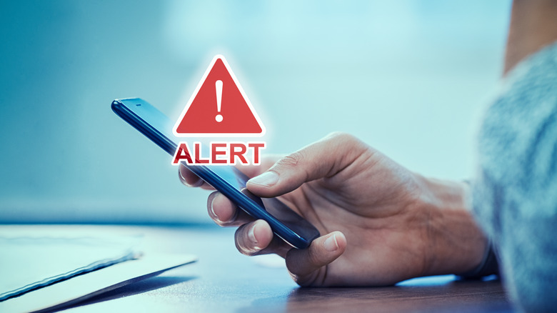 Alert icon over a phone